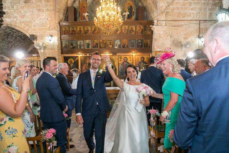 Happy Couple leaving Ayia Kyriaki after Anglican, Christian wedding in Paphos, Cyprus.