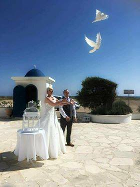 Releasing doves into blue sky and sunshine after marrying in Paphos with the Anglican Church of Paphos.